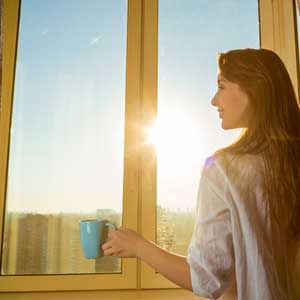 Woman Opening Curtains